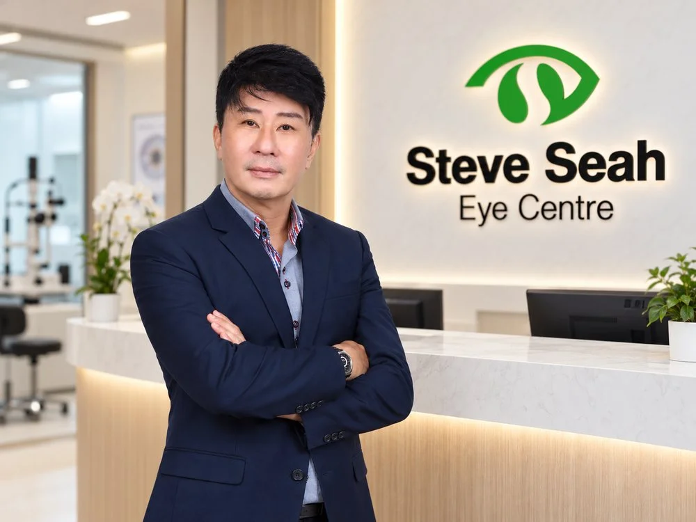 Dr. Steve Seah posing at the reception counter of Steve Seah Eye Centre